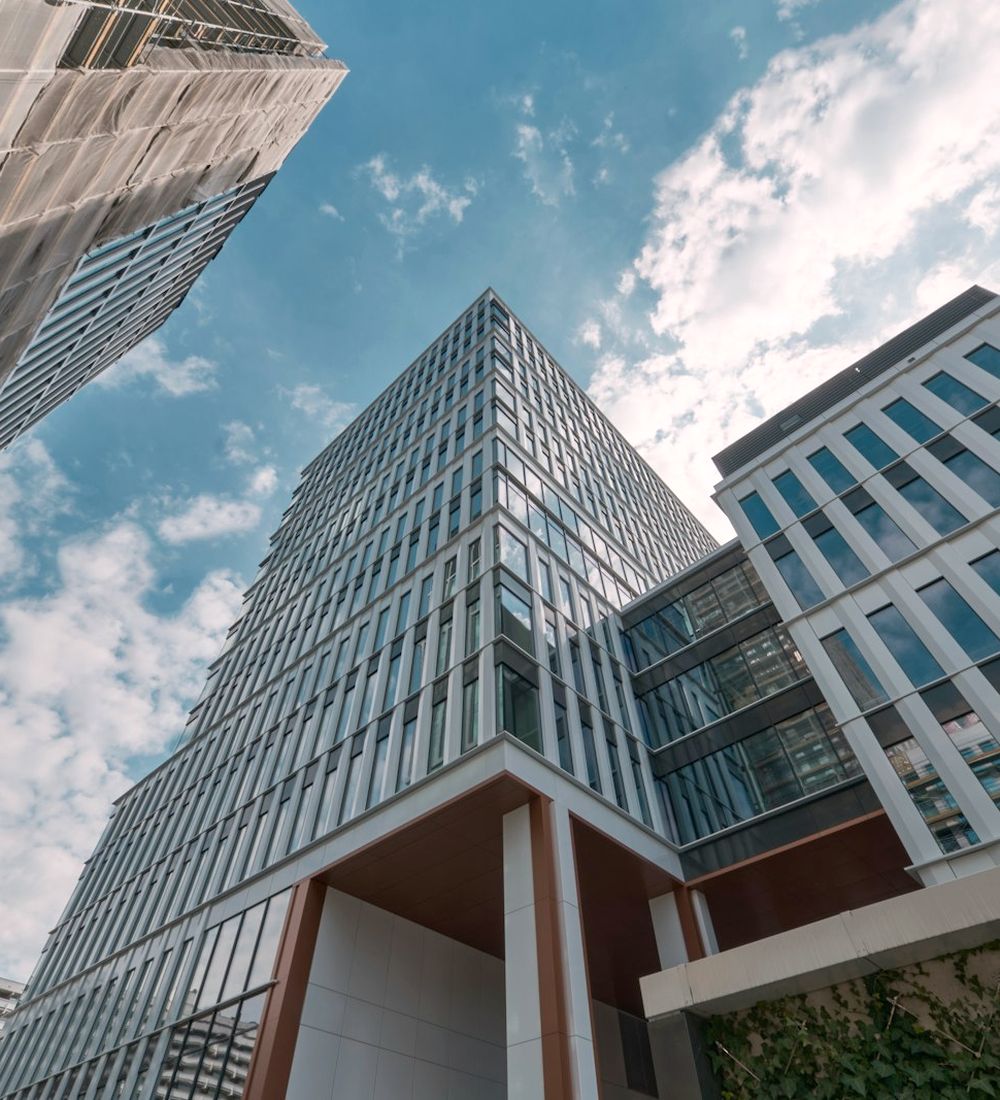Modern glass office buildings against a blue sky