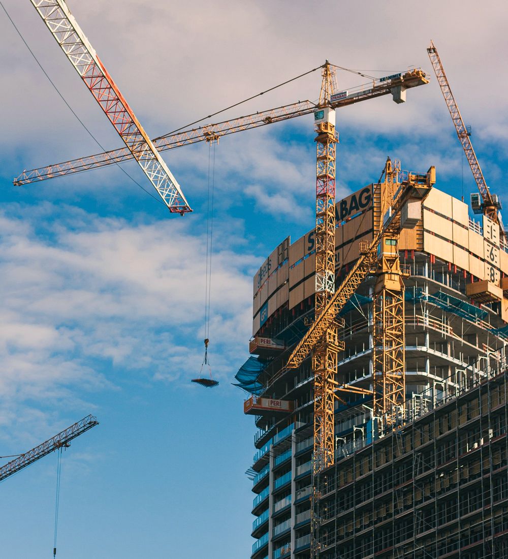 High-rise under construction with tower cranes