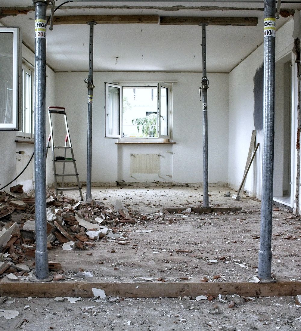 Gutted room mid-renovation with temporary support posts
